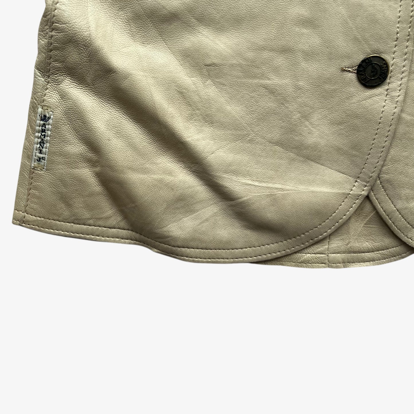 Armani Jeans brand tag on women's vintage Y2K cream leather blazer.