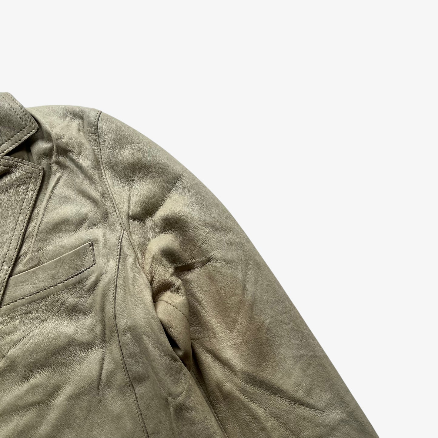 Patina on women's vintage Y2K Armani Jeans cream leather blazer.
