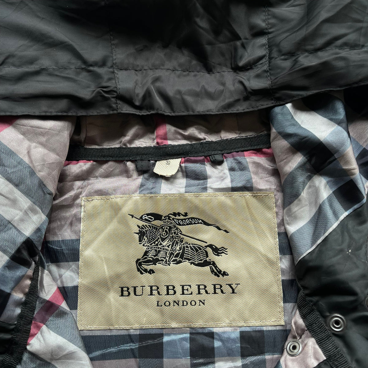 Burberry London label stitched inside of vintage Y2K women's black hooded jacket.