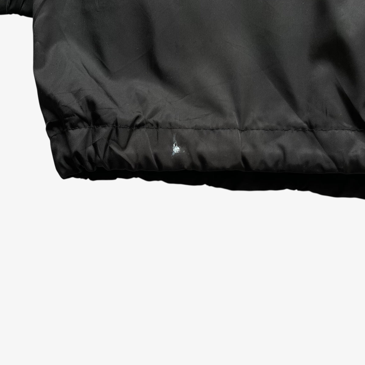 Marked hem of vintage Y2K women's Burberry black hooded jacket.
