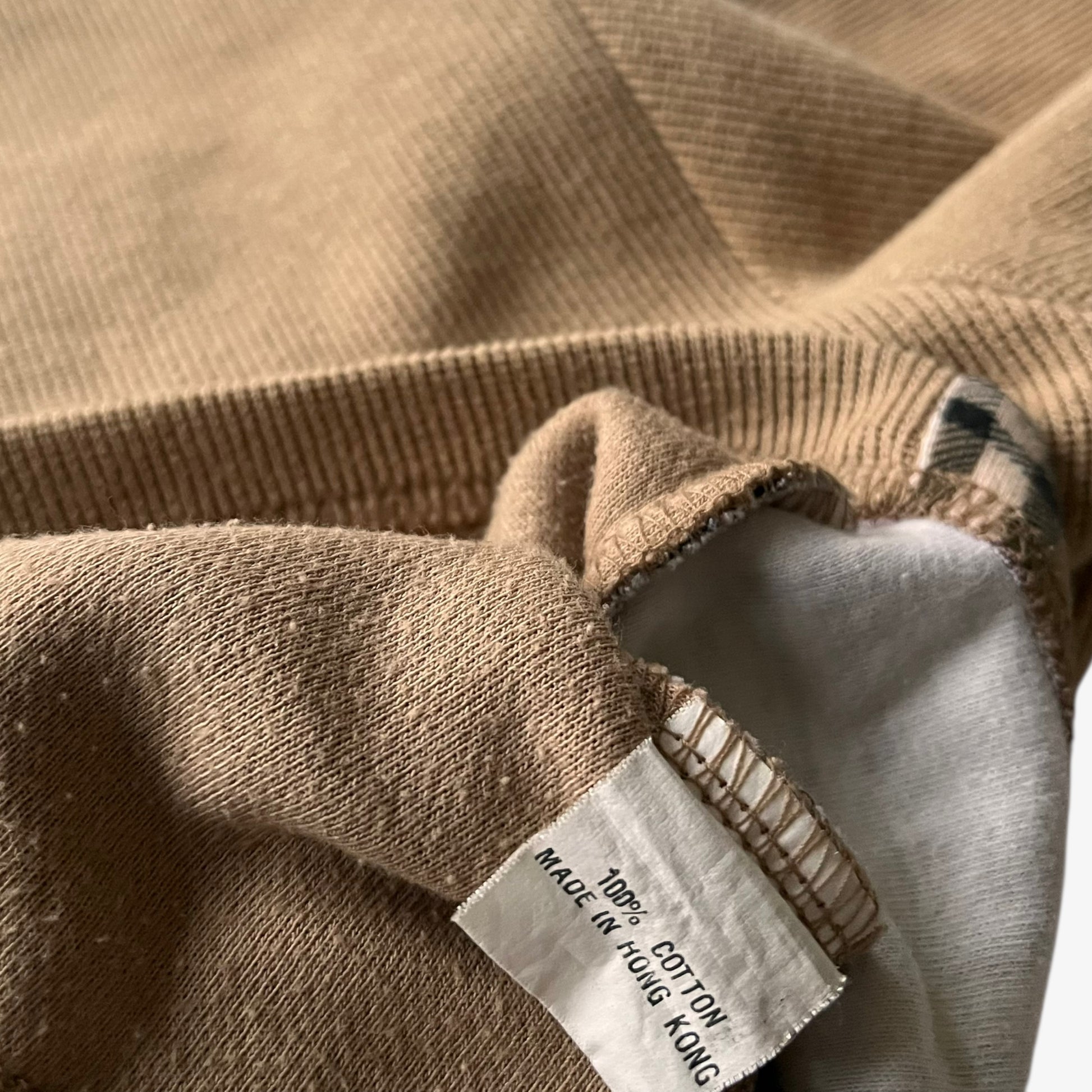Inside label of a vintage Y2K women's Burberry cotton turtleneck jumper featuring a nova check stripe.