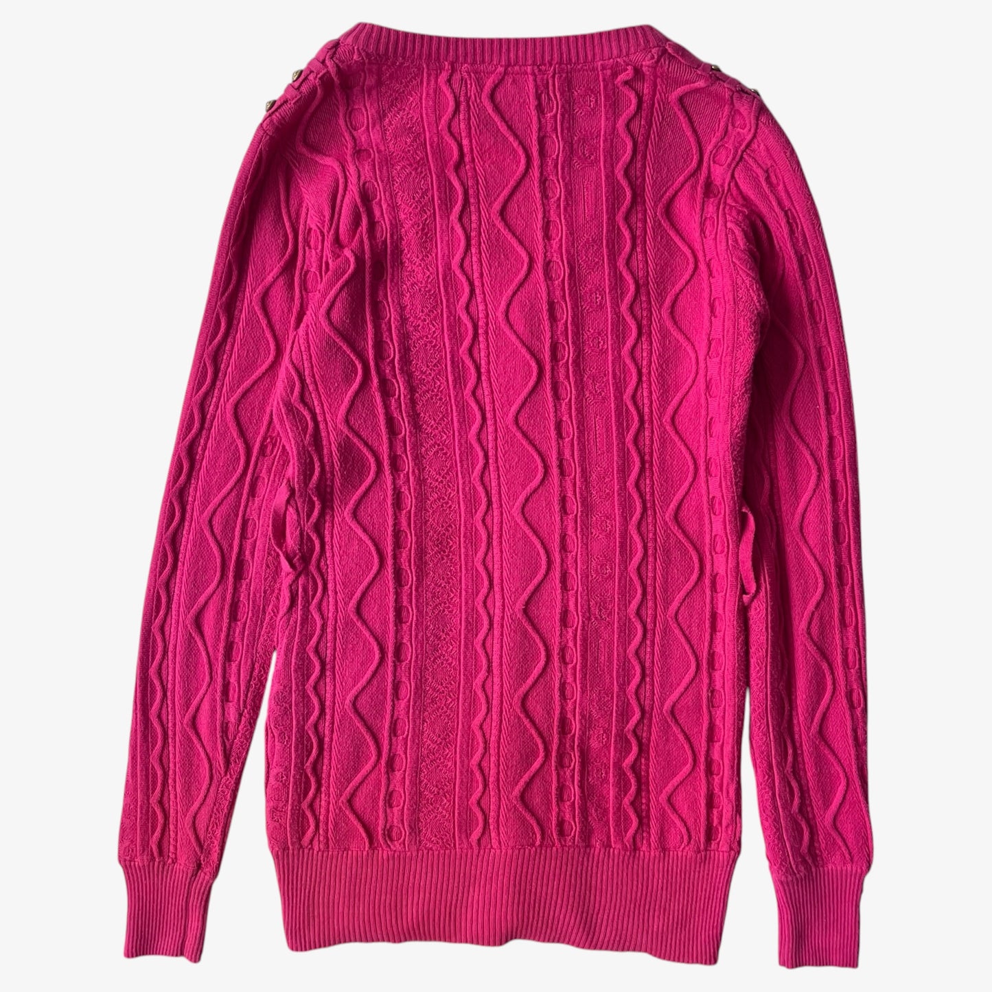 Vintage Coogi pink cable knit sweater on a white background.