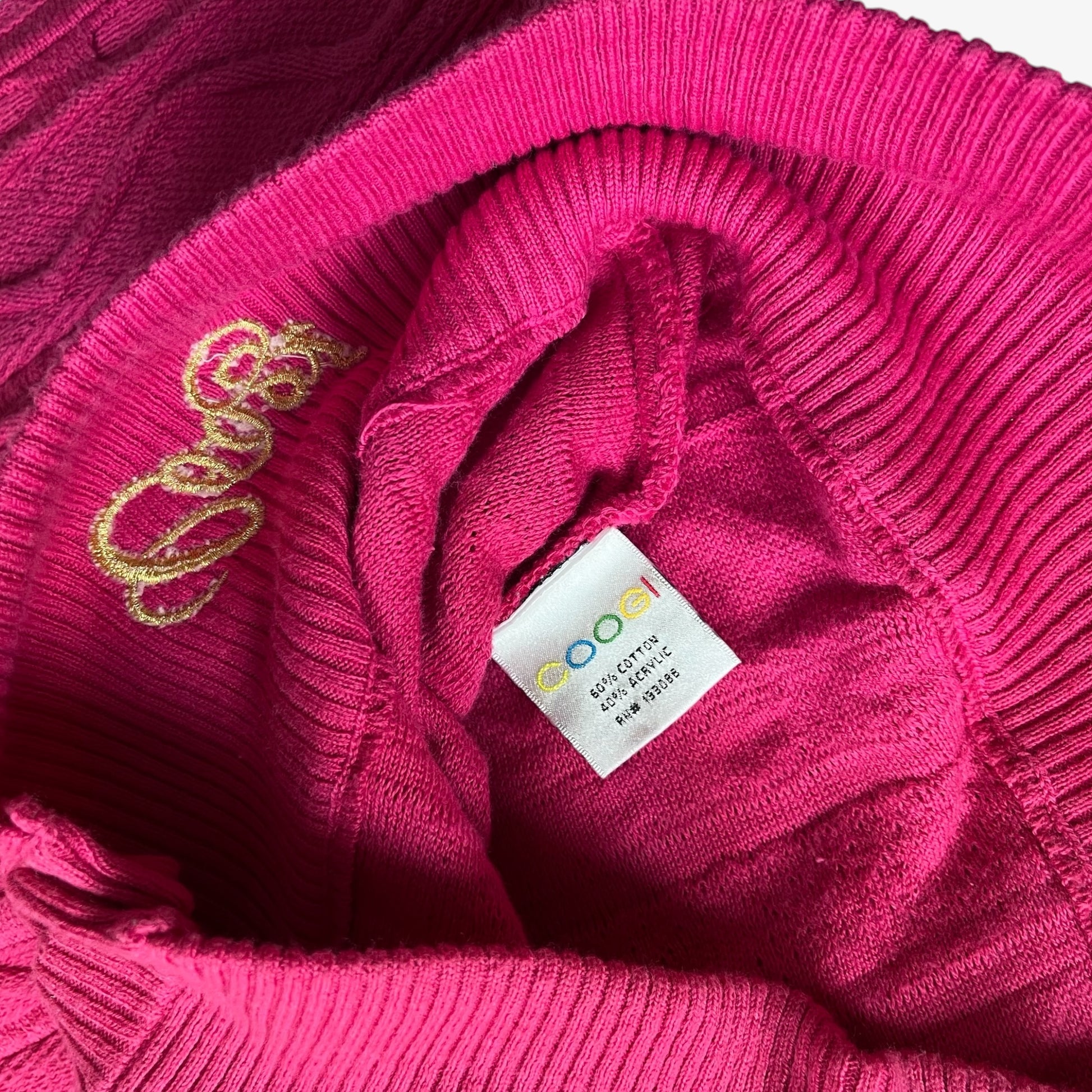 Pink knit sweater with a vintage Coogi brand tag.