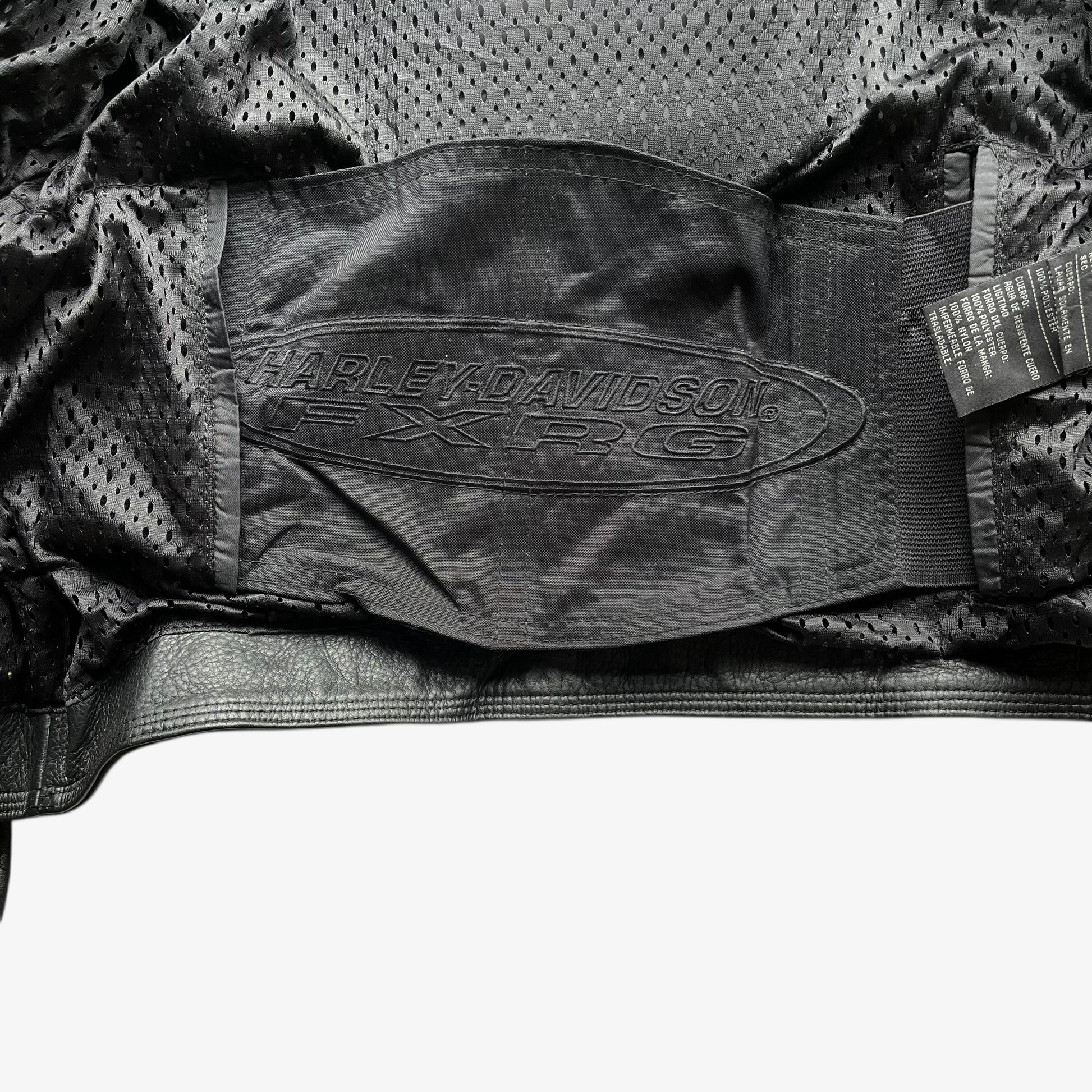 Harley Davidson FXRG logo on inside belt of vintage Y2K women's Harley Davidson FXRG Series 1 padded black leather biker jacket.