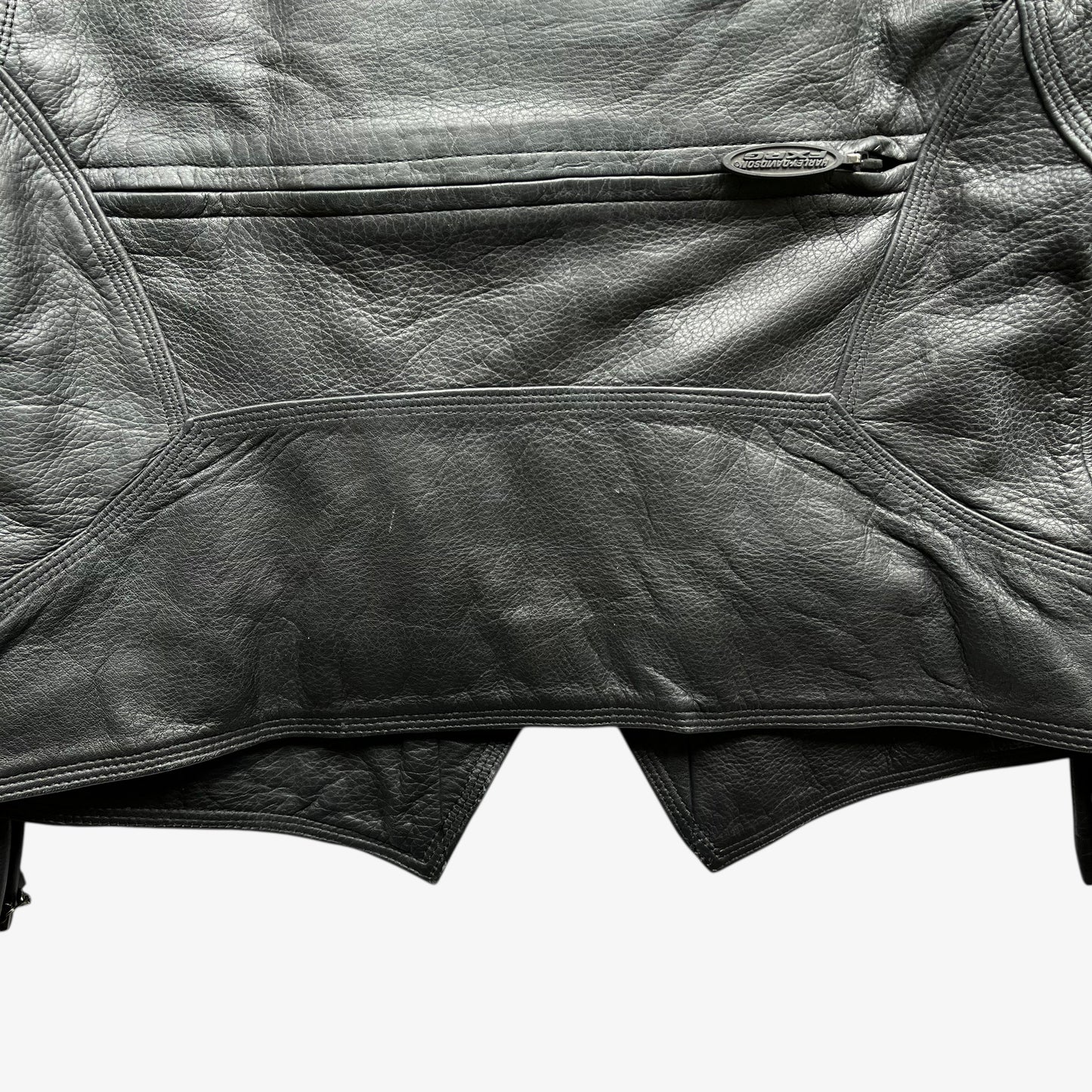 Back hem of vintage Y2K women's Harley Davidson FXRG Series 1 padded black leather biker jacket.