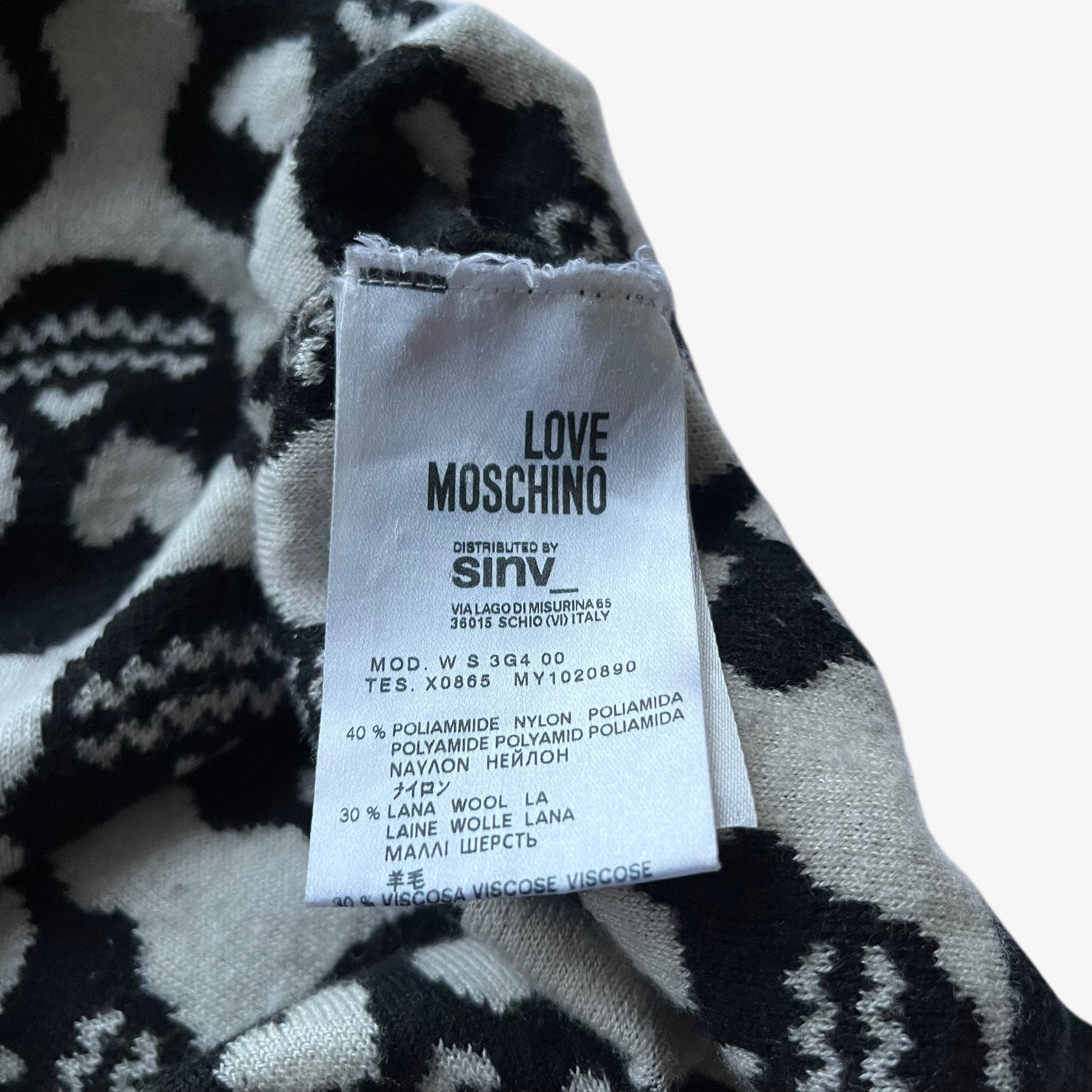 Love Moschino label stitched inside of women's vintage Y2K geometric skull print black wool blend jumper.