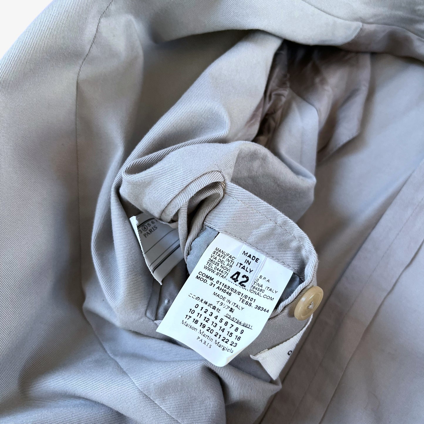 Care label stitched inside of vintage Y2K women's Maison Margiela double breasted grey trench coat.