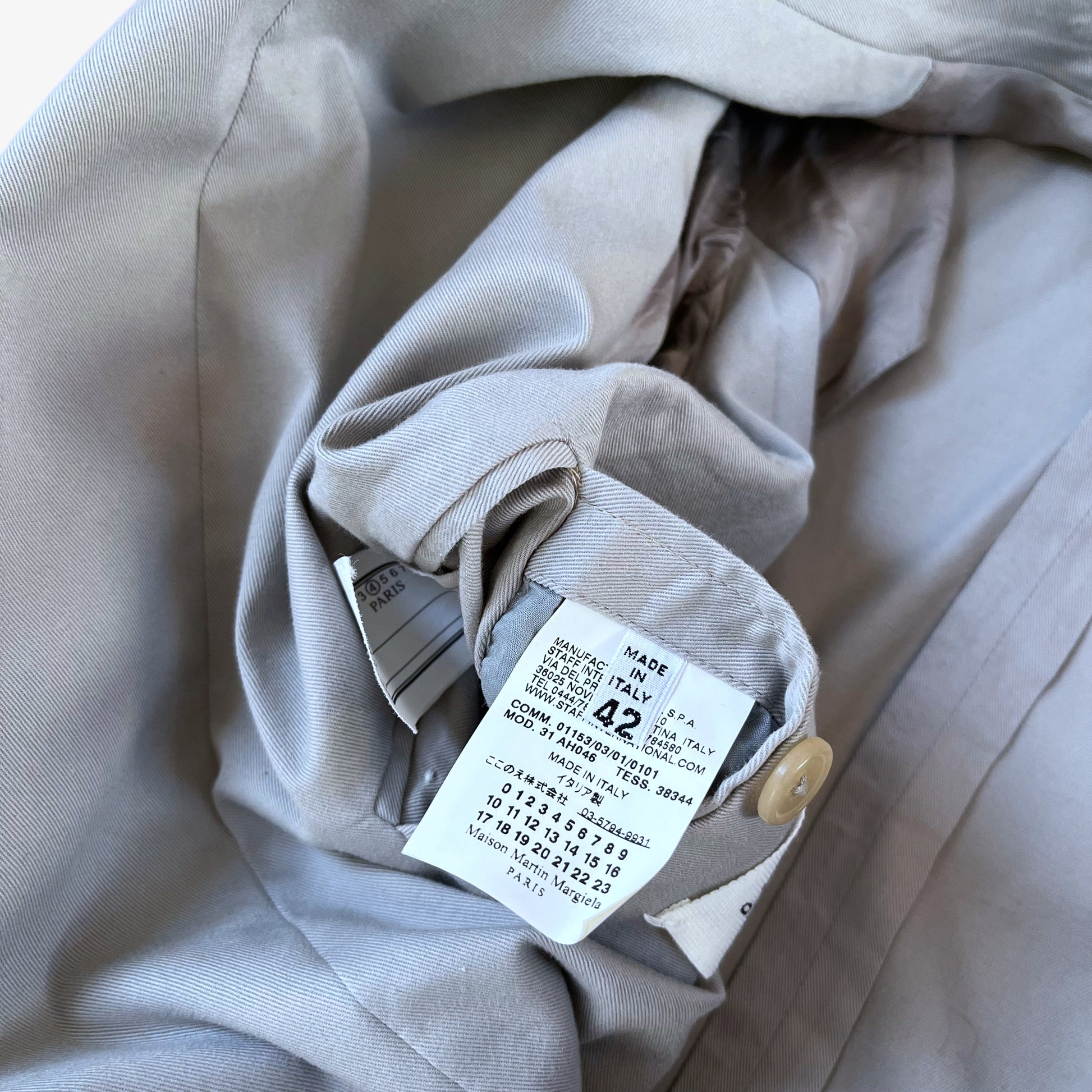 Care label stitched inside of vintage Y2K women's Maison Margiela double breasted grey trench coat.
