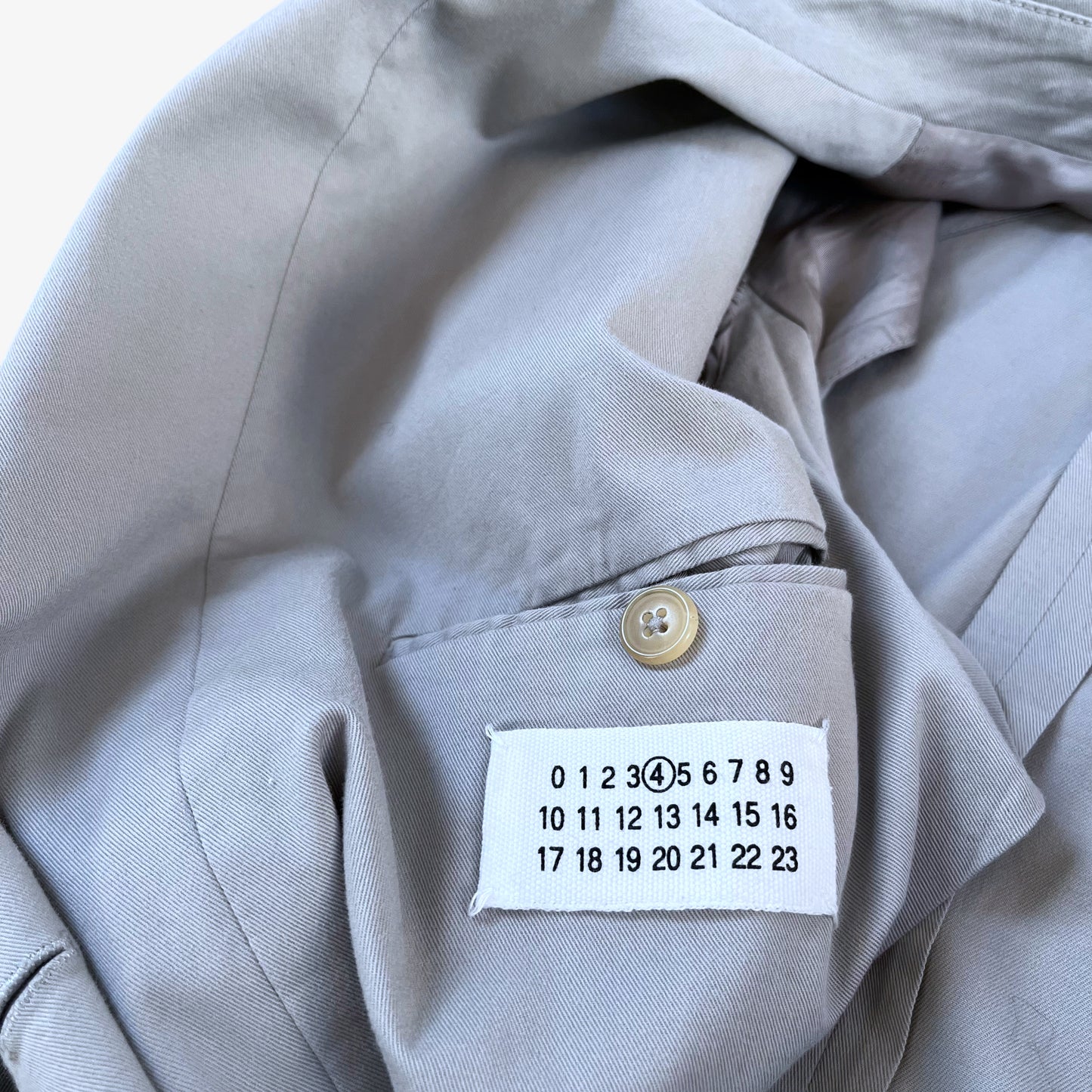 Maison Margiela label stitched inside of vintage Y2K women's double breasted grey trench coat.