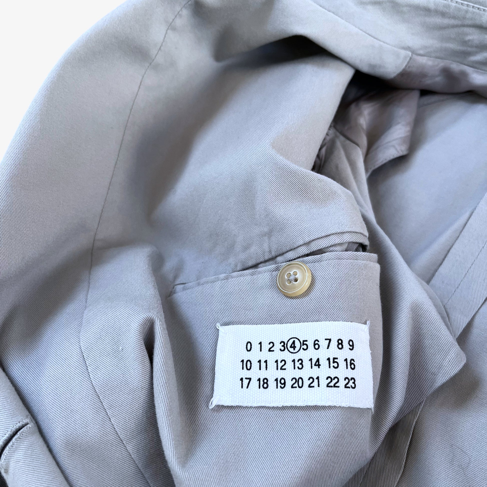 Maison Margiela label stitched inside of vintage Y2K women's double breasted grey trench coat.