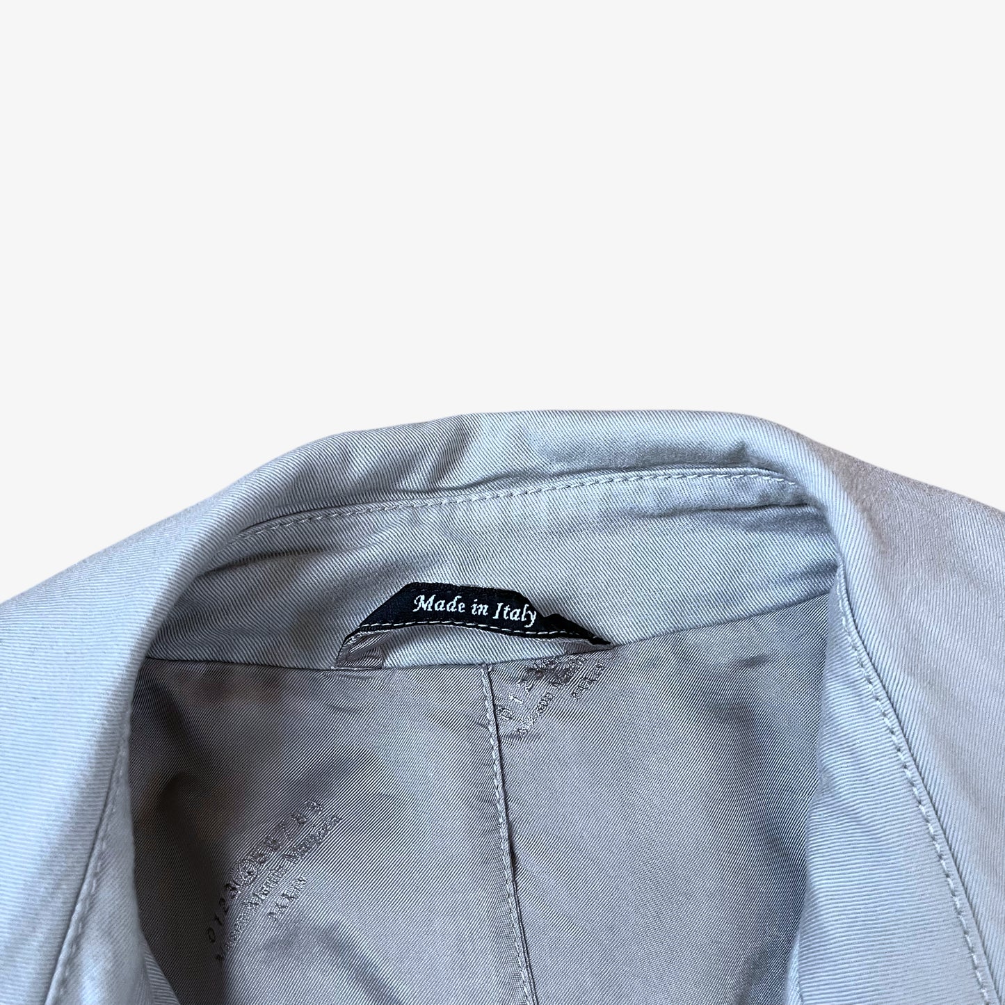 Made In Italy label stitched inside of vintage Y2K women's Maison Margiela double breasted grey trench coat.