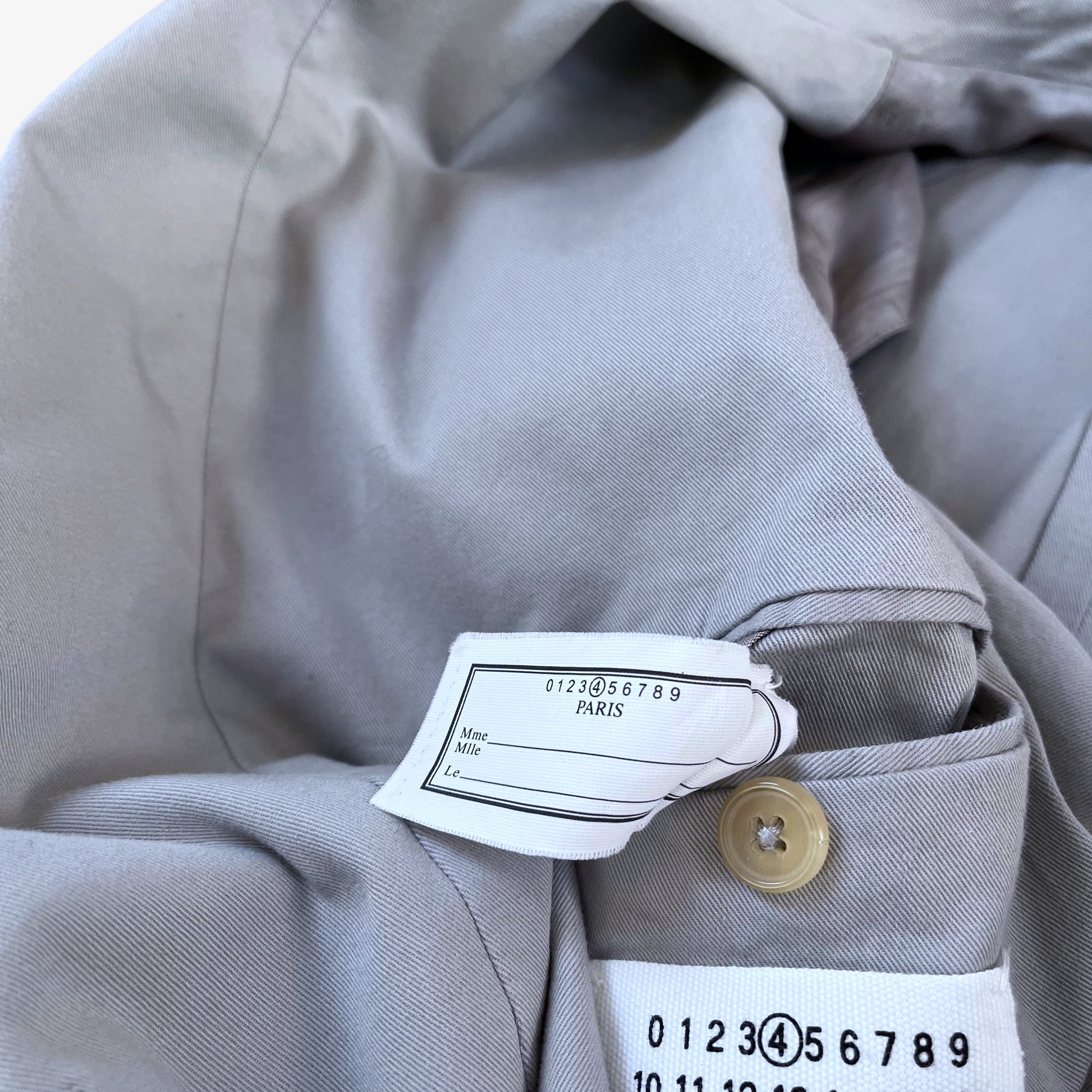 Tag inside of vintage Y2K women's Maison Margiela double breasted grey trench coat.