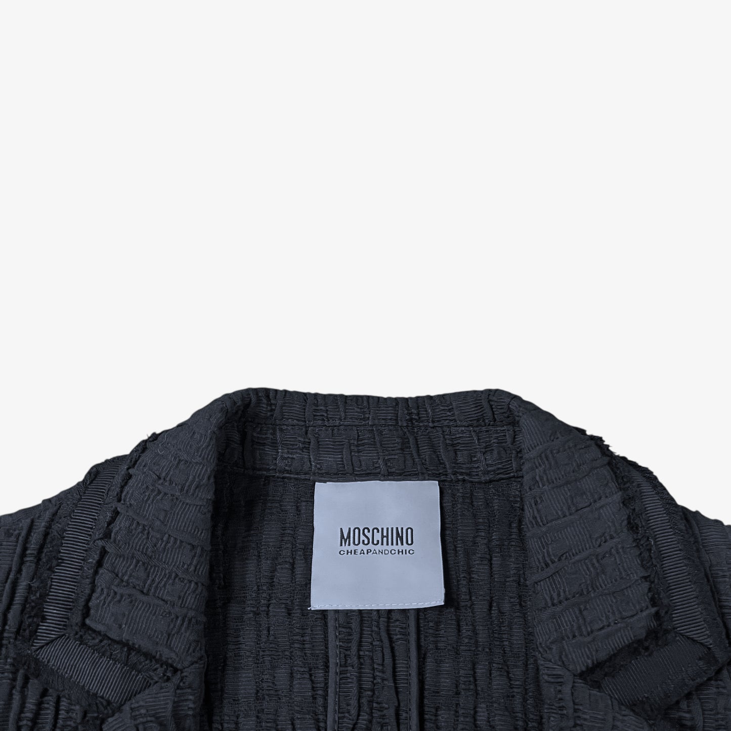 Label of vintage Y2K Moschino women’s black ribbed blazer.