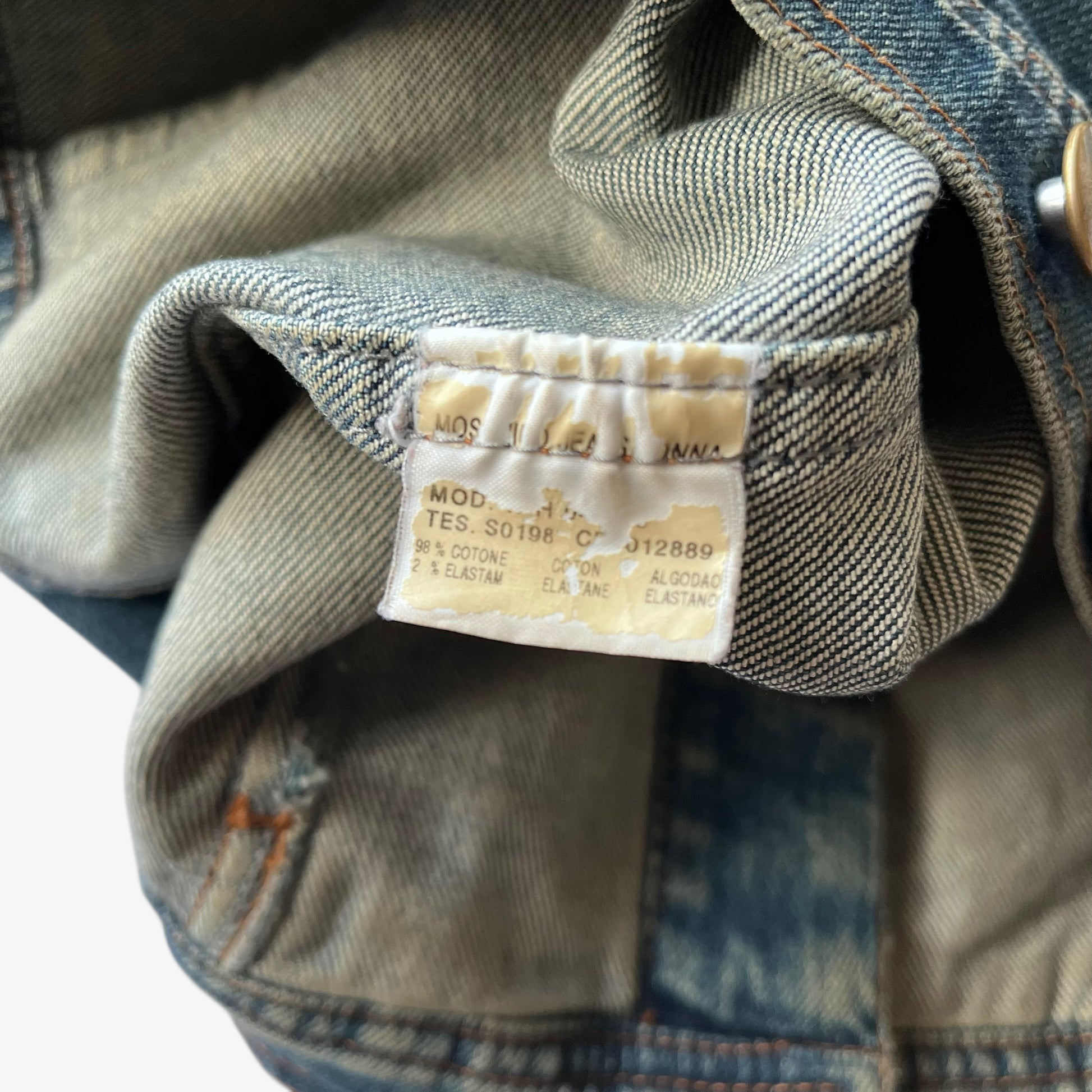 Inside label of vintage Y2K women's Moschino jeans blue denim trucker jacket.