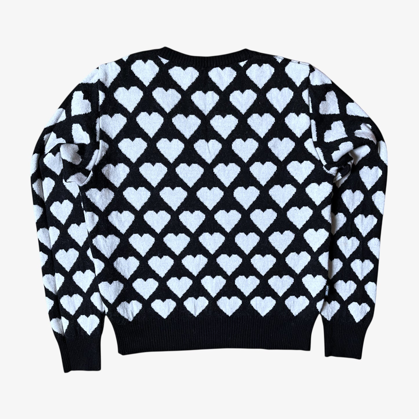 Back of vintage Y2K Moschino Jeans women's black and white v-neck wool jumper with heart pattern.