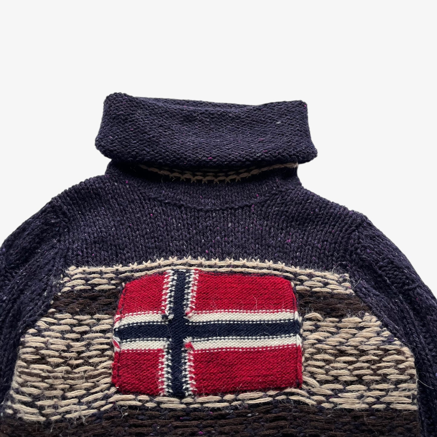 Close up of embroidered Norway flag on a vintage women's Napapijri purple wool turtleneck jumper.
