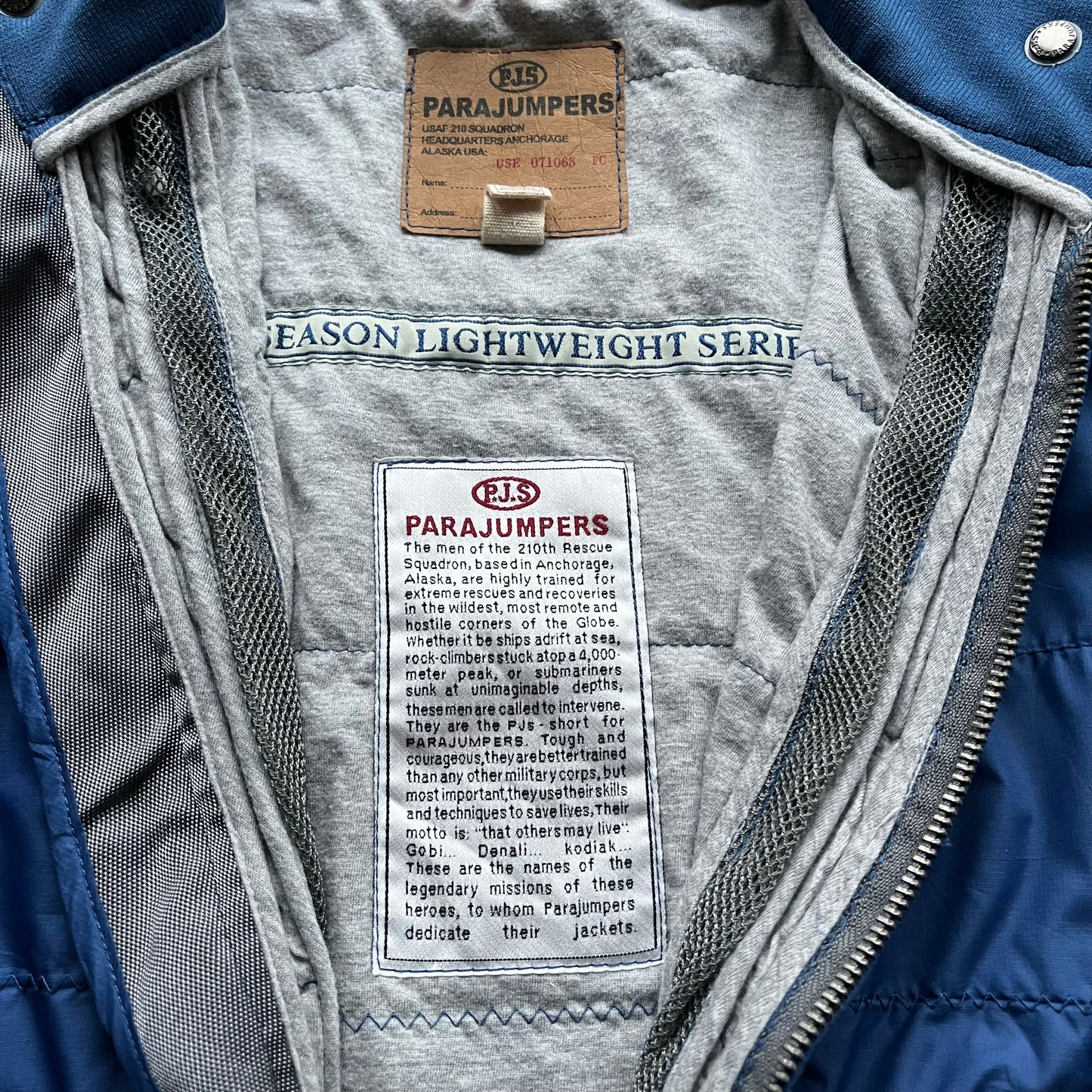 Inside label of vintage Y2K women's Parajumpers USAF 210 rescue squadron blue utility jacket.