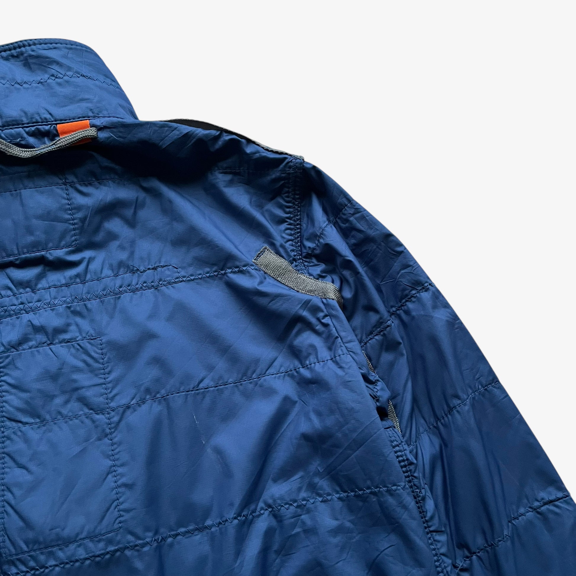 Patina of vintage Y2K women's Parajumpers USAF 210 rescue squadron blue utility jacket.