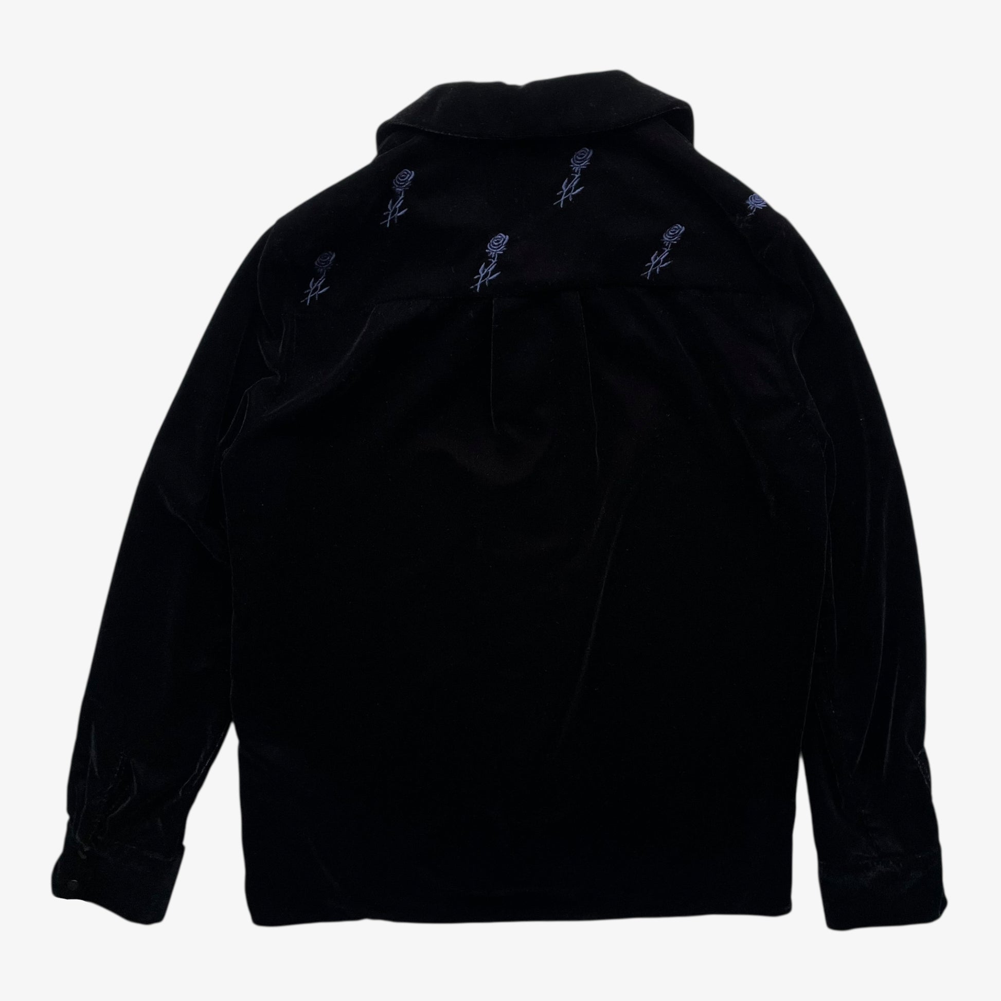 Back of women's Maje black velour shirt with embroidered floral details on a white background.