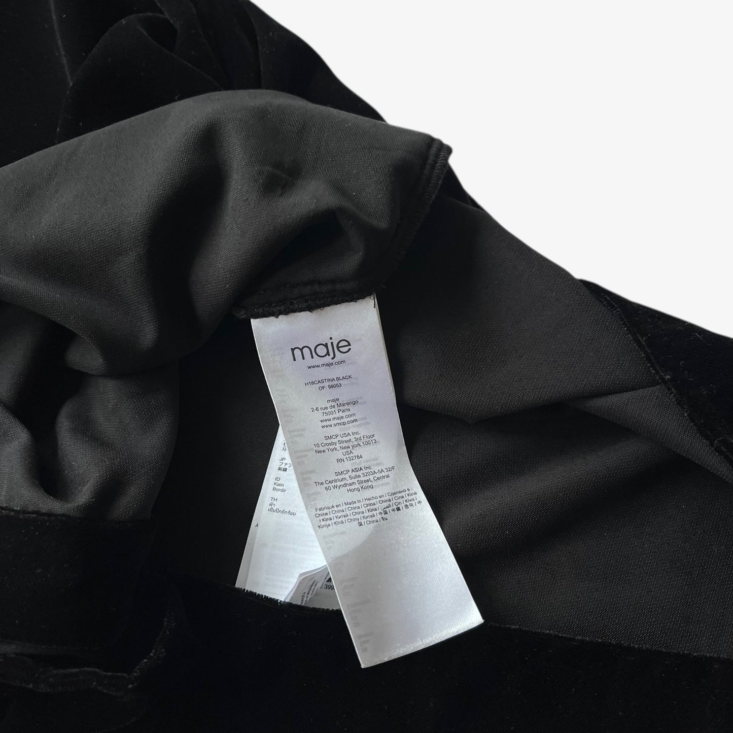 Black velour shirt with a Maje label on a white background.