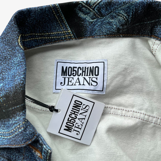 Close-up of a women's denim jacket collar showing the blue denim fabric, interior lining, and two visible Moschino Jeans brand tags.