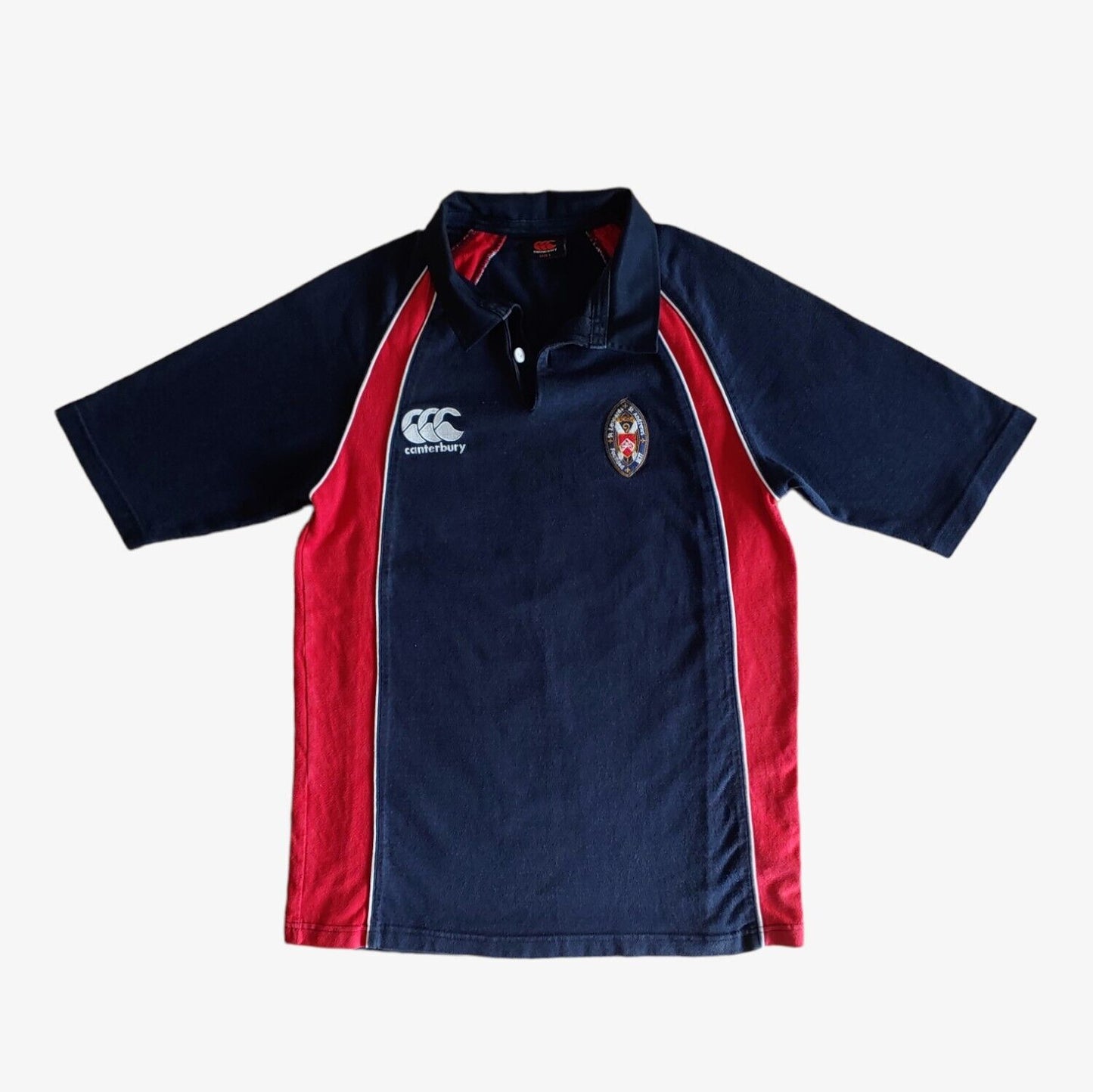 A navy and red Canterbury St Andrews rugby shirt with embroidered crest, short sleeves, and a classic fit.