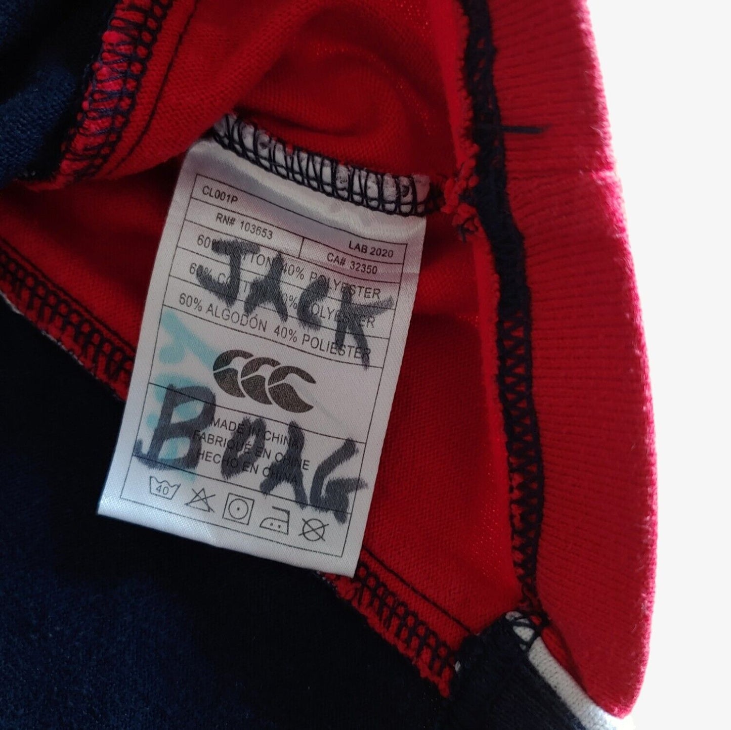 Inside label of navy and red Canterbury St Andrews rugby shirt.