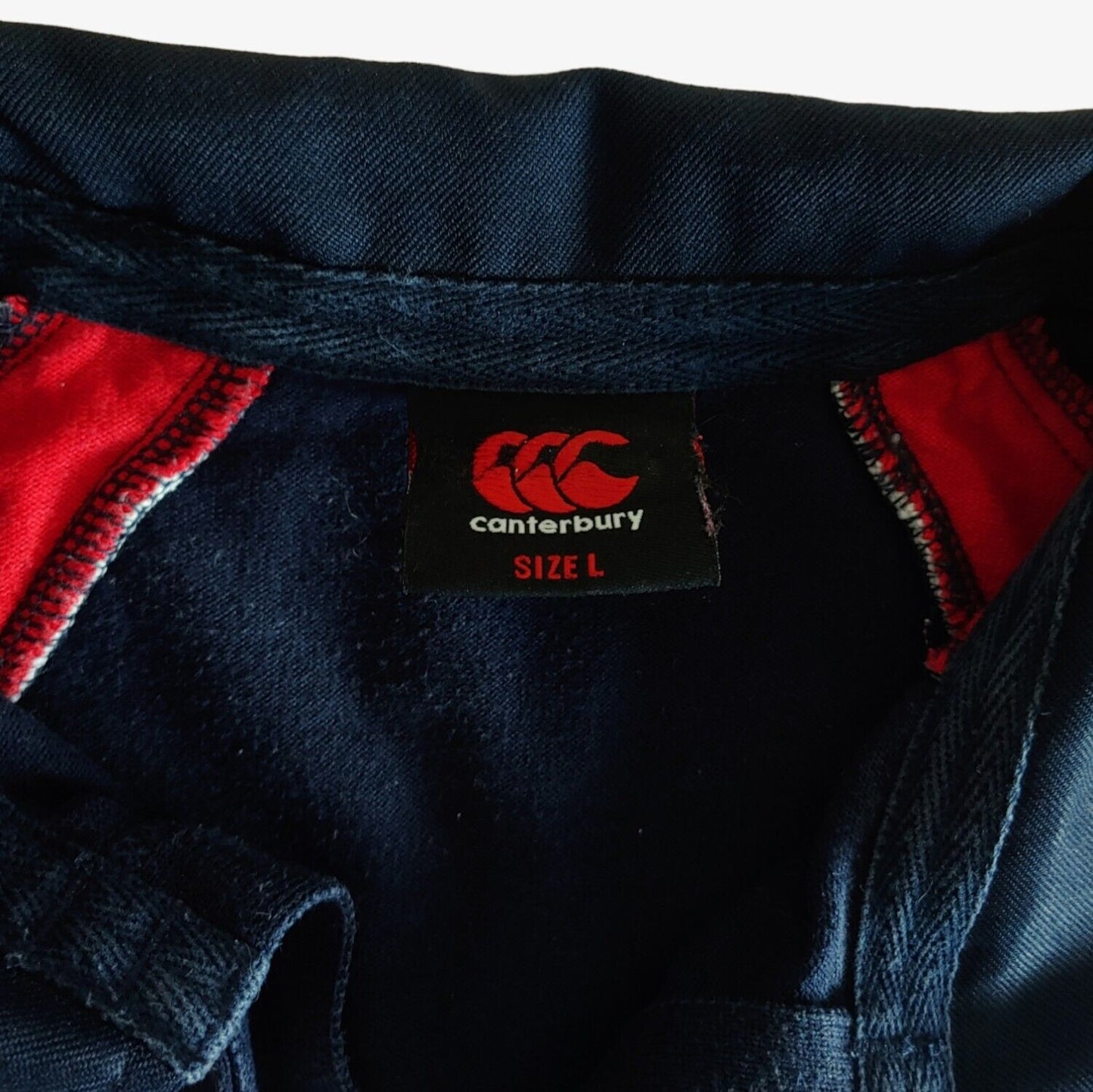 Label of navy and red Canterbury St Andrews rugby shirt.