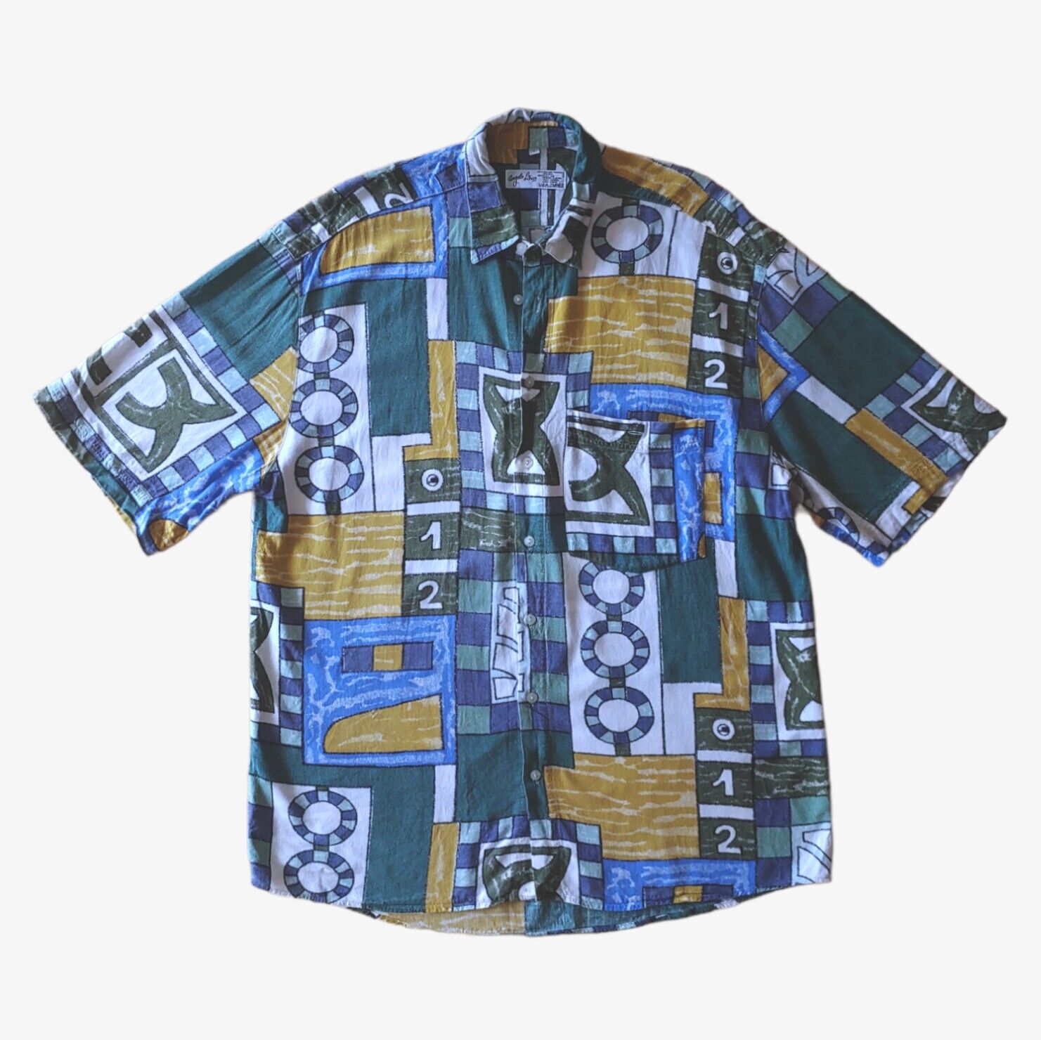 A vintage 90s men's Angelo Litrico short-sleeve shirt with a colourful geometric sailing boat print.