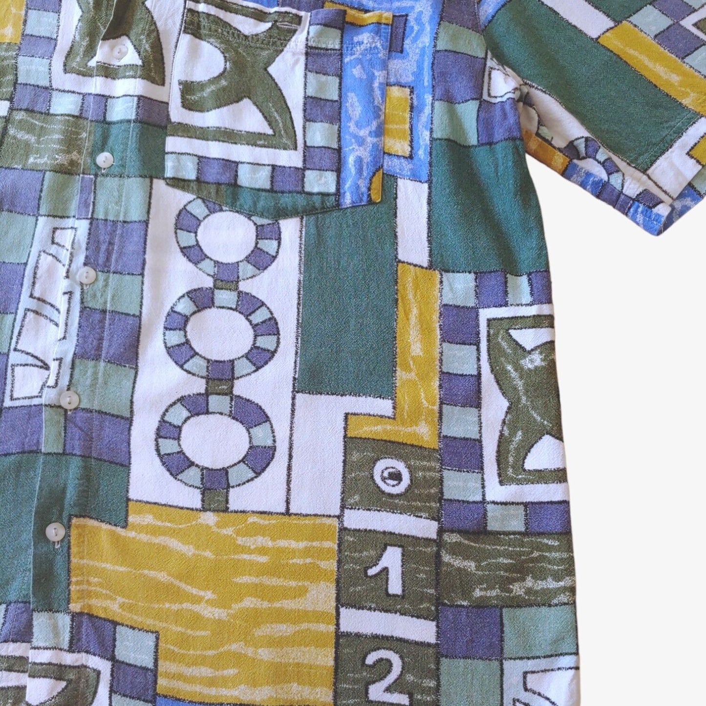 Close up of vintage 90s men's Angelo Litrico short-sleeve shirt with a colourful geometric sailing boat print.