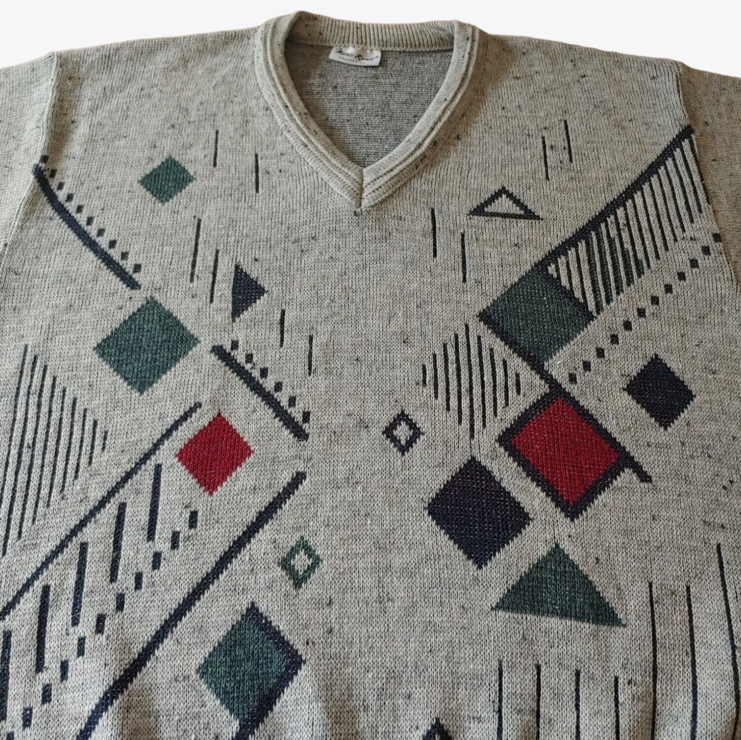 Close up of vintage 90s men's Marc Rene abstract V-neck grey jumper with geometric pattern.