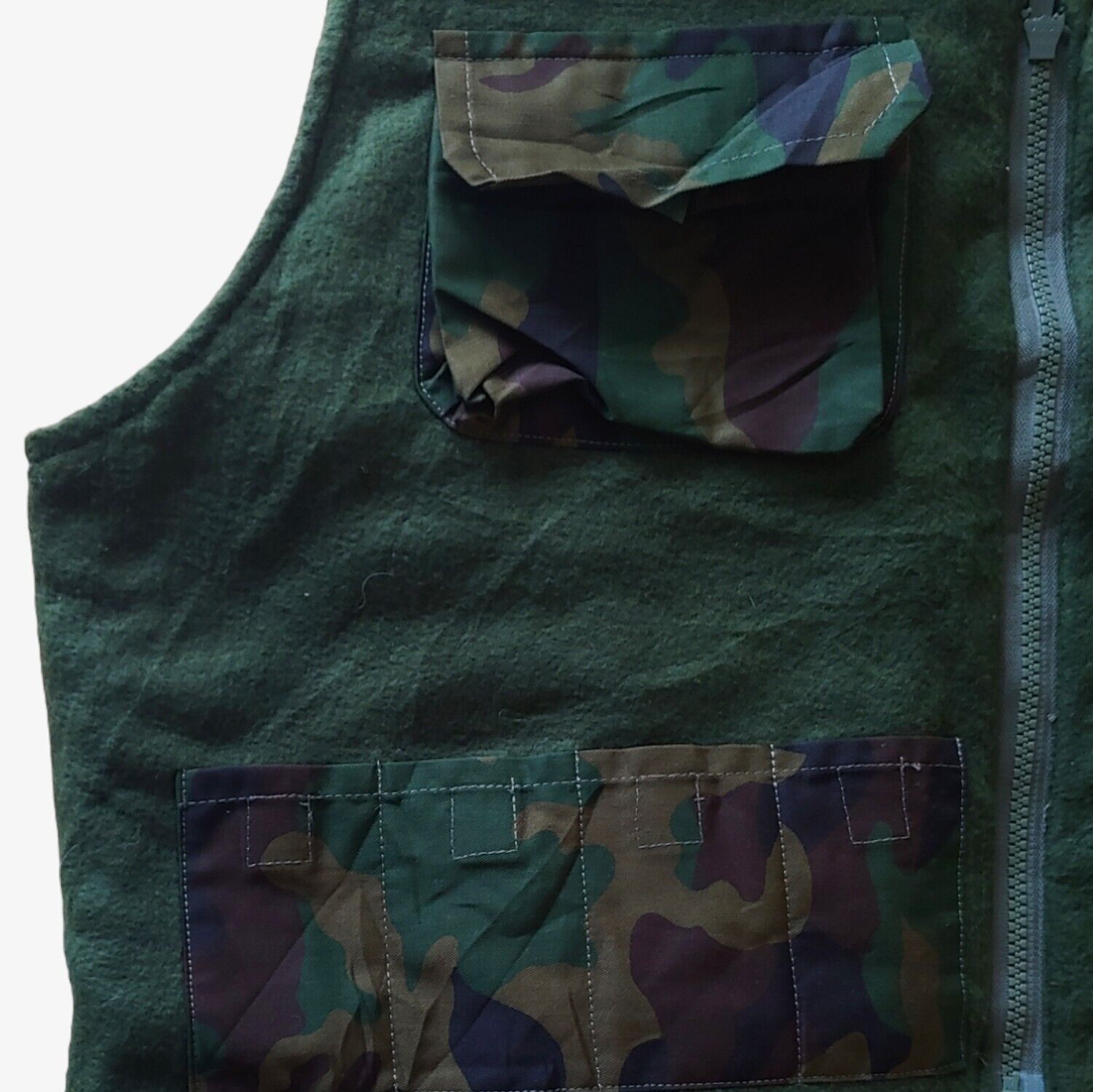 Inside tactical pockets of vintage 90s New Contrast camouflage hunting utility gilet.