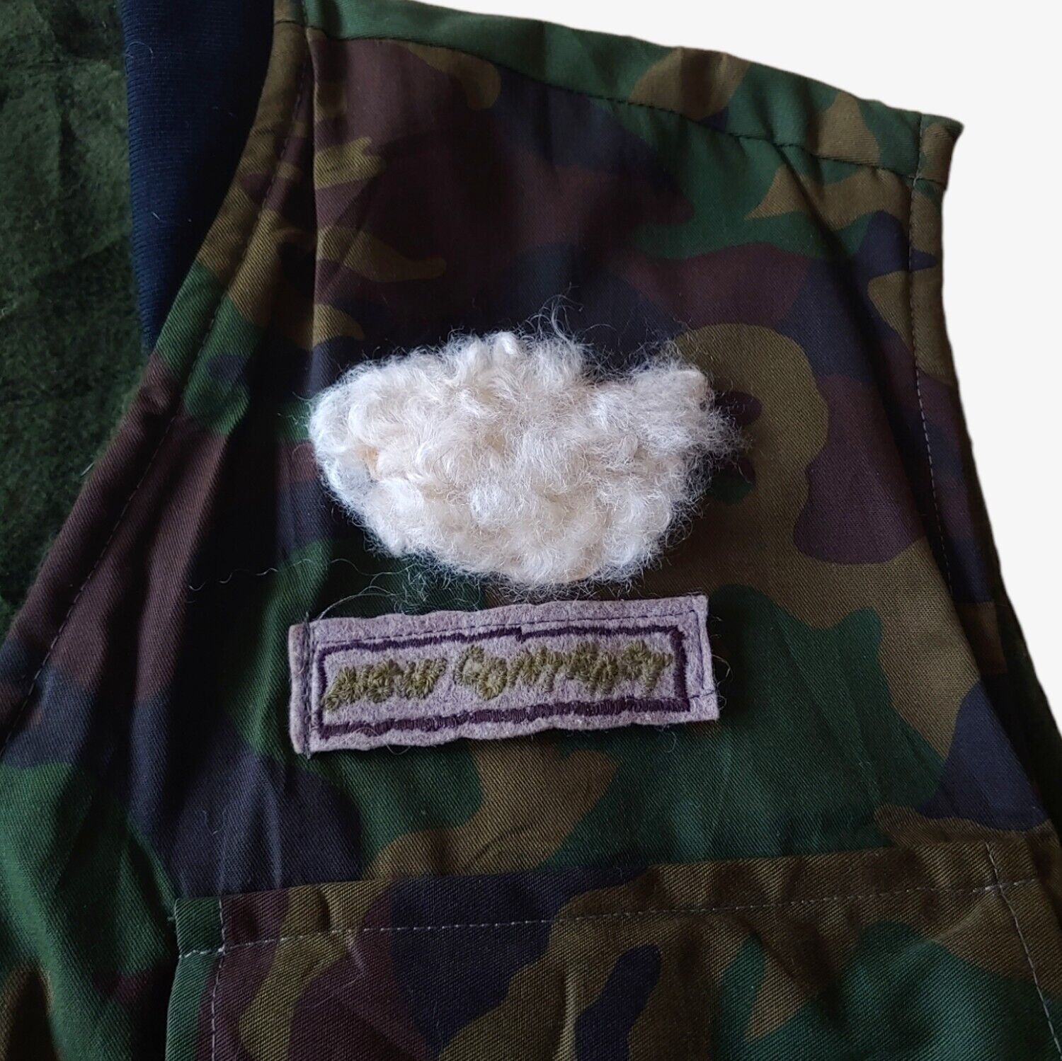 Embroidered logo on vintage 90s New Contrast camouflage hunting utility gilet.