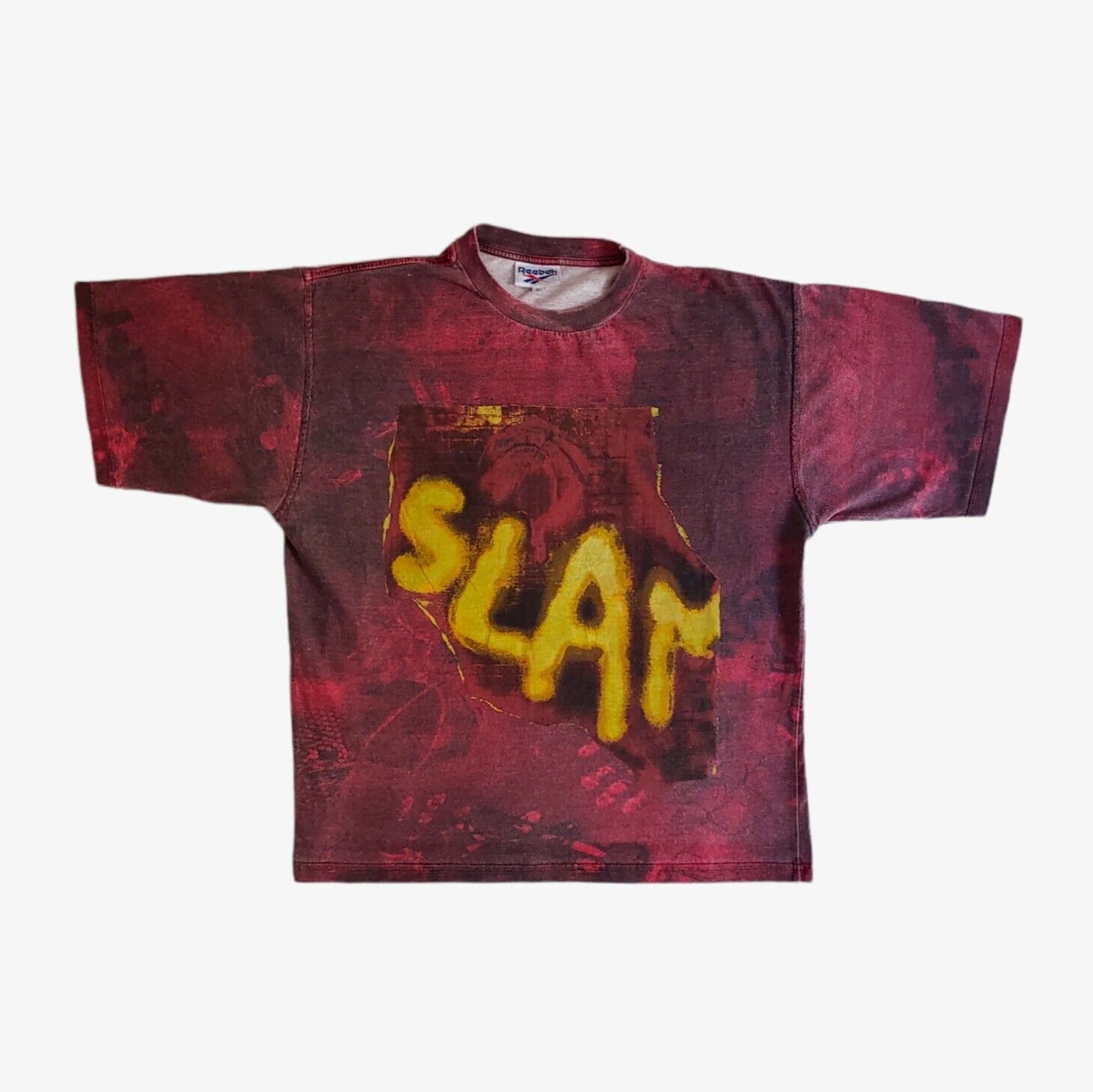 A red vintage 90s men's Reebok tie-dye t-shirt with 'SLAM' printed in yellow bold letters on the front.