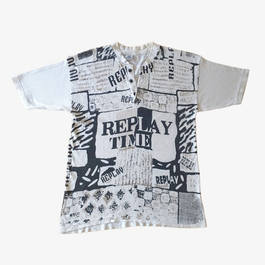 A vintage 90s men's white t-shirt with black all over print text and graphics, featuring a ribbed texture and short sleeves.