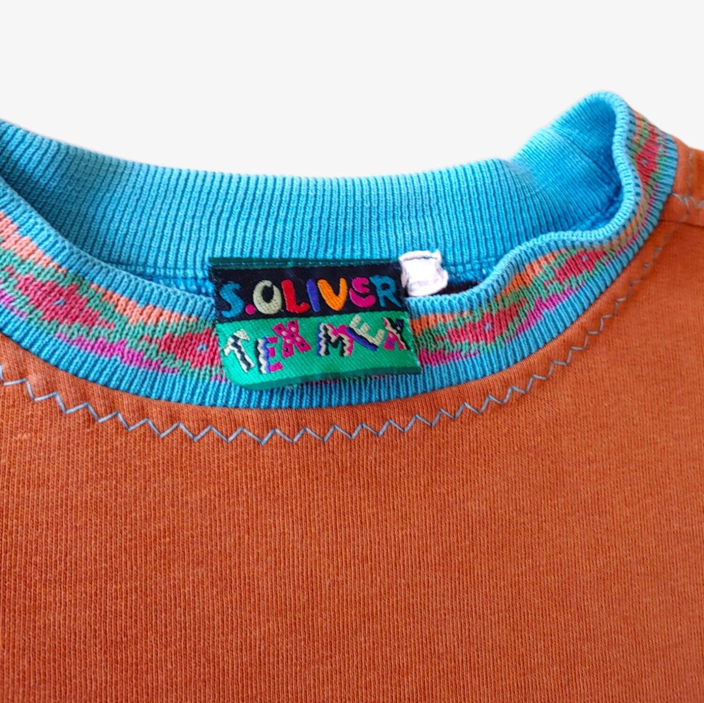 Label of A vintage orange S.Oliver Mexico souvenir sweatshirt with a patterned collar.