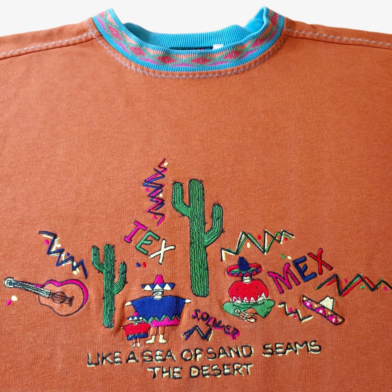 Close up of embroidery vintage orange S.Oliver Mexico souvenir sweatshirt with a patterned collar.
