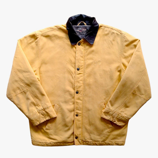 A vintage Scotch & Soda yellow workwear jacket with black leather trim collar, displayed on a plain background.