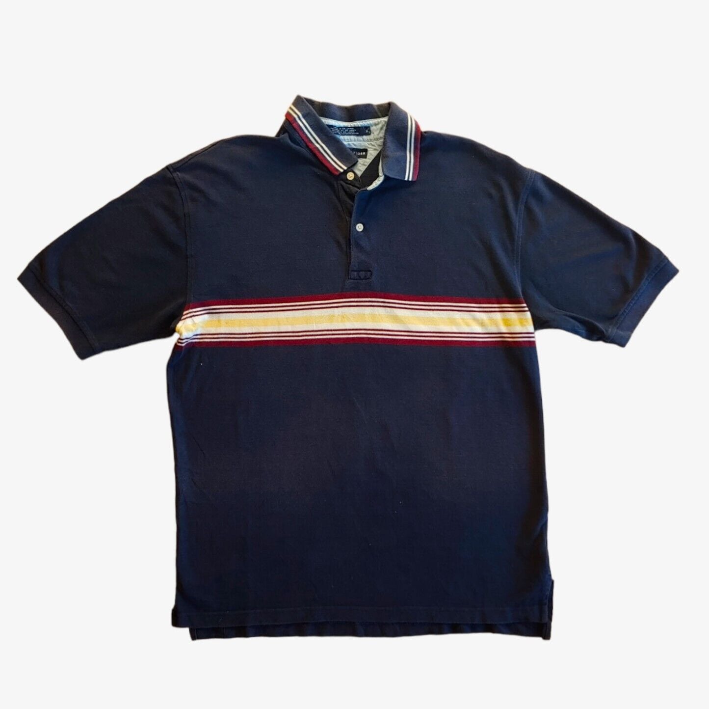 A vintage Tommy Hilfiger striped polo shirt in navy, with a colourful stripe, short sleeves, and a collar.