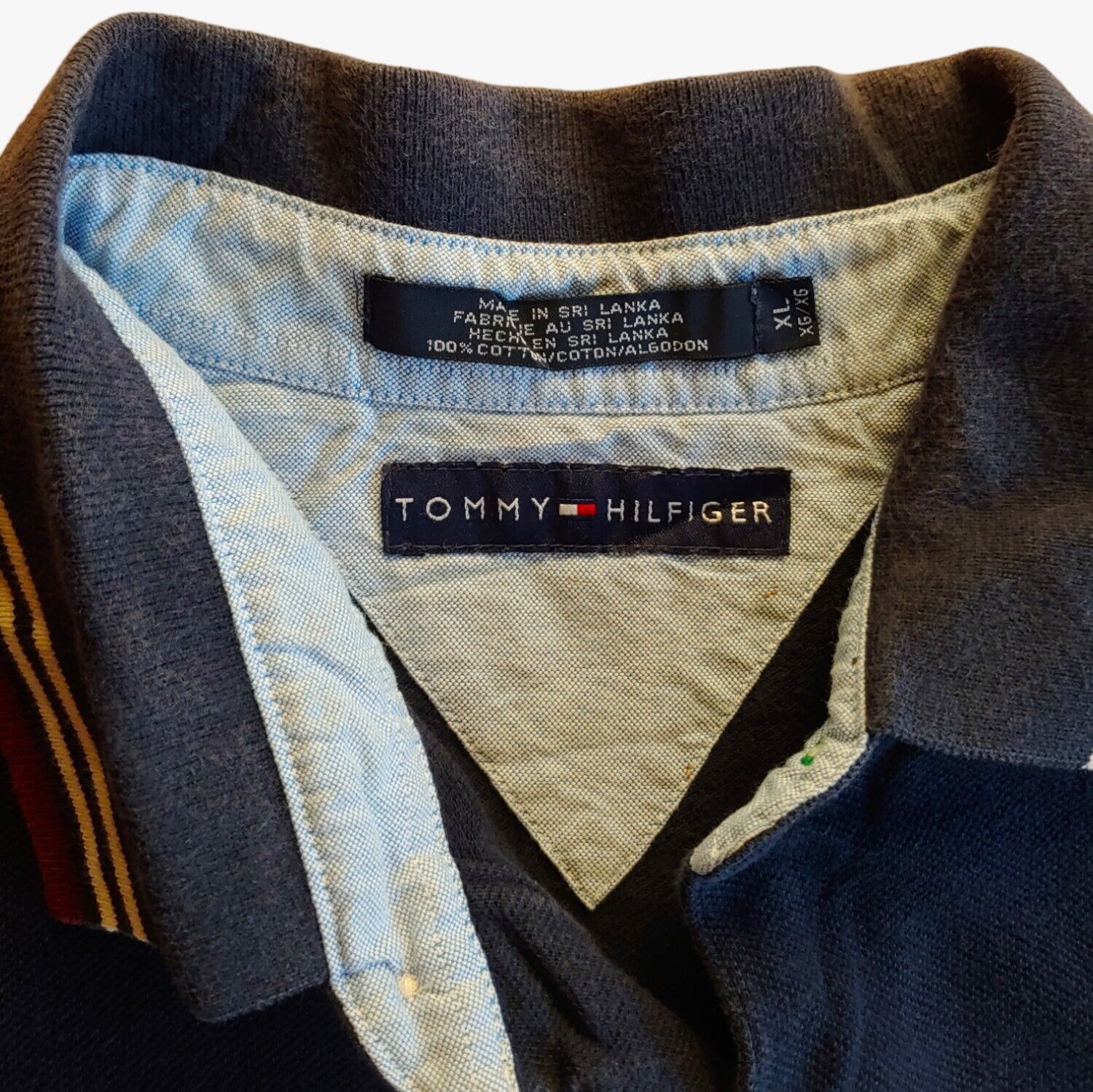 Label of a vintage Tommy Hilfiger striped navy polo shirt.