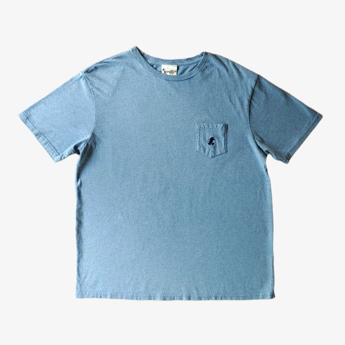 A vintage blue Walt Disney World men's t-shirt with a chest pocket and embroidered logo.