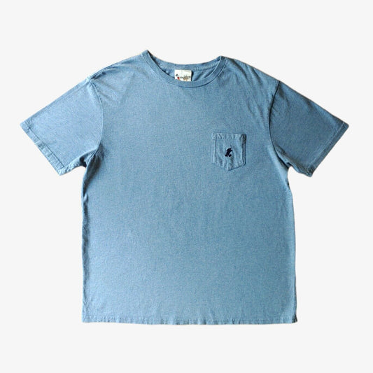 A vintage blue Walt Disney World men's t-shirt with a chest pocket and embroidered logo.