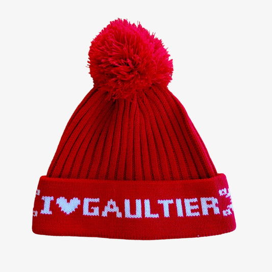 A red beanie with 'I love GAULTIER' text pattern.