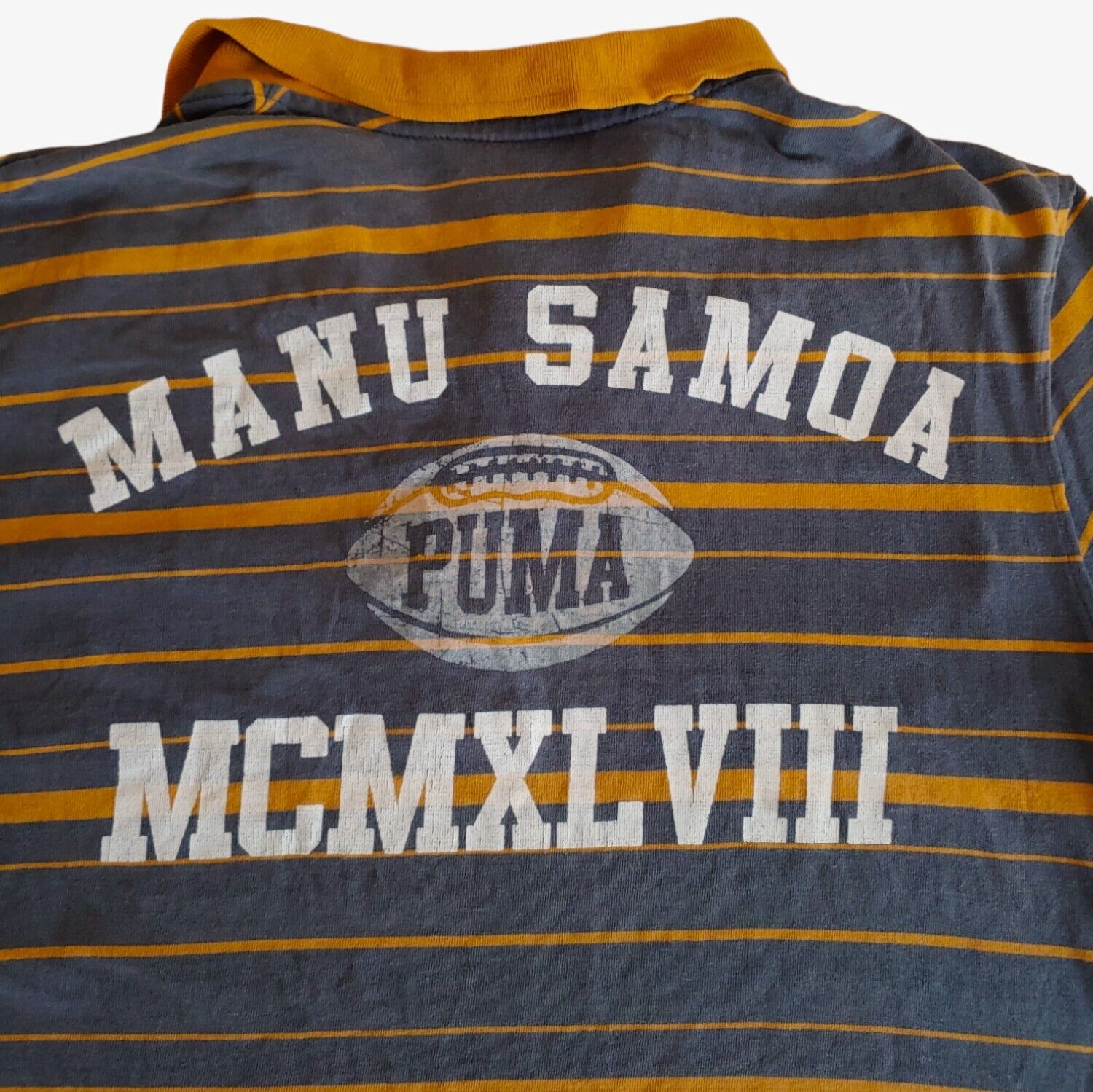Close up of vintage Y2K Puma Manu Samoa New Zealand striped rugby polo shirt.