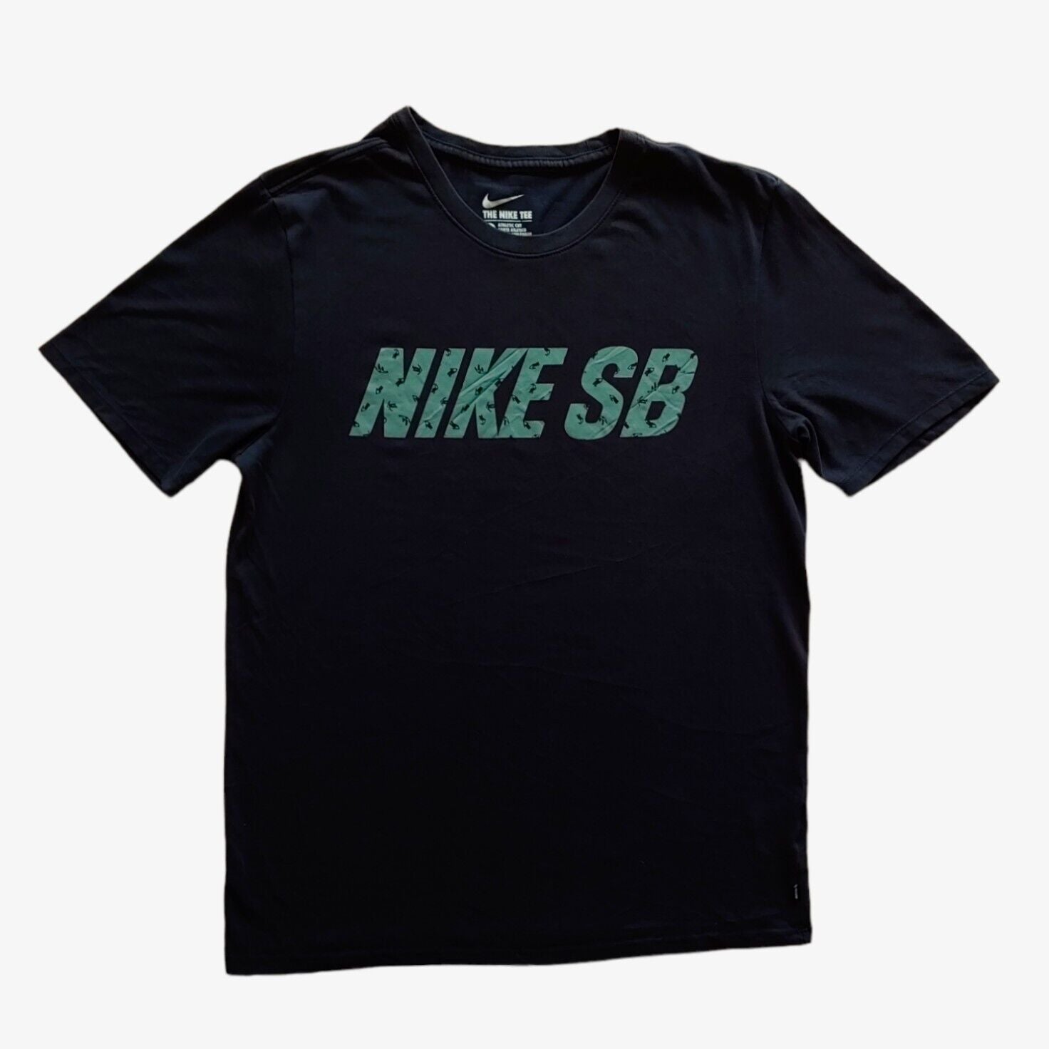 A black Nike SB crewneck t-shirt with the brand's logo in green across the front.